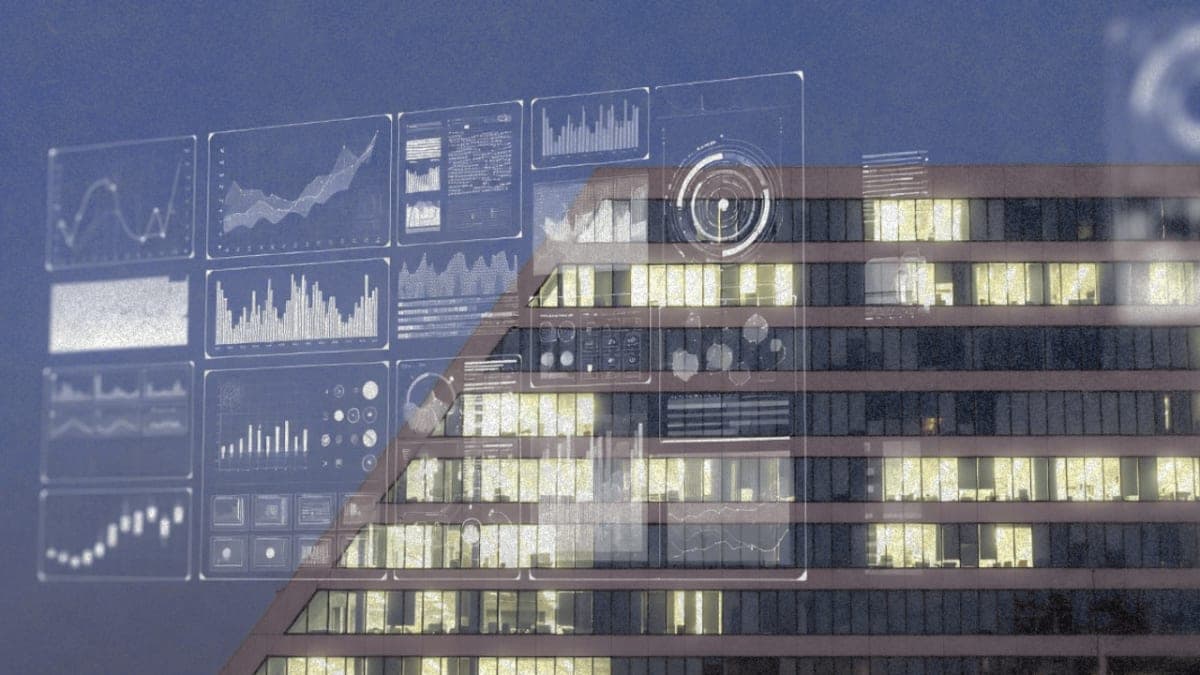 Office building with some dark windows and AI interface overlay representing workforce reductions