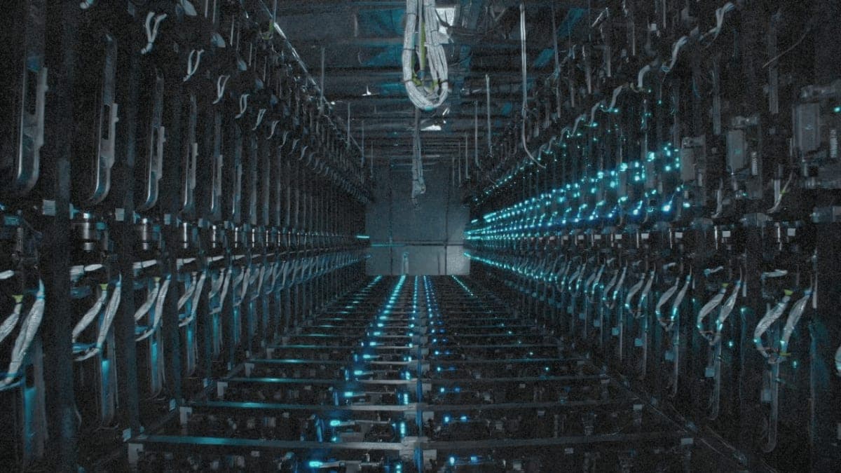 Interior of large-scale AI data center with rows of GPU server racks and cooling infrastructure