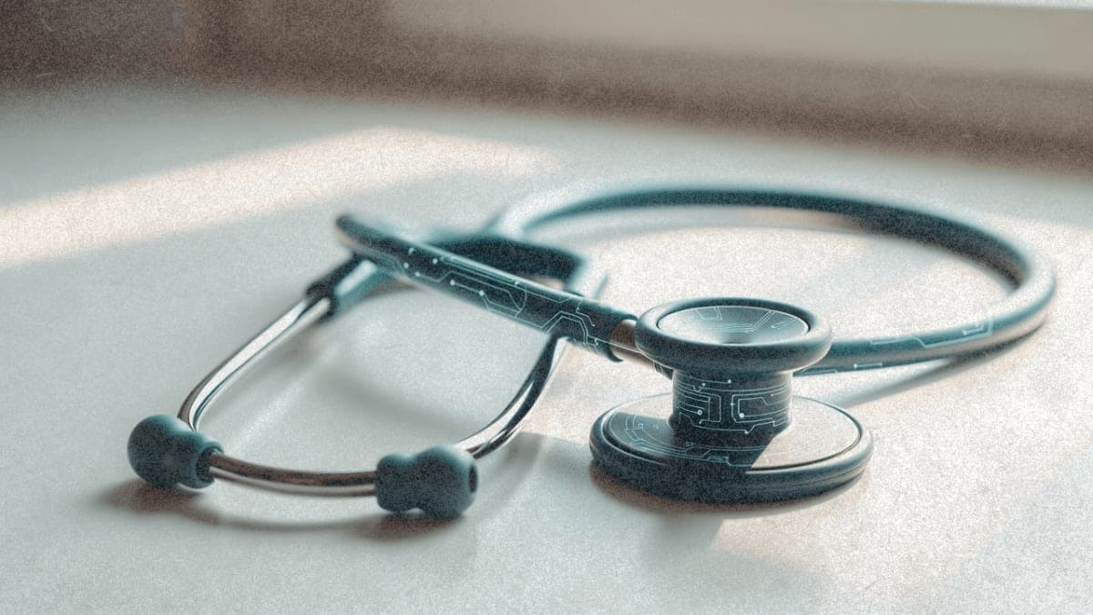 Stethoscope with integrated digital circuitry patterns on white clinical surface