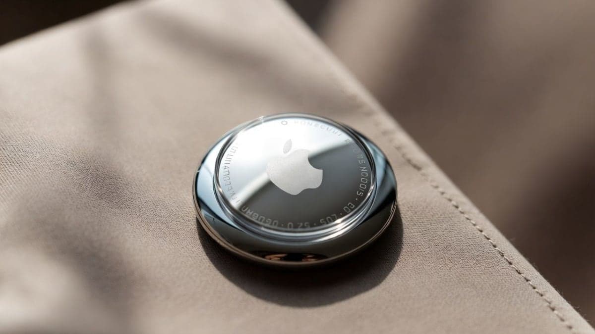 Apple's rumored AI wearable pin concept showing a small circular device similar in size to an AirTag