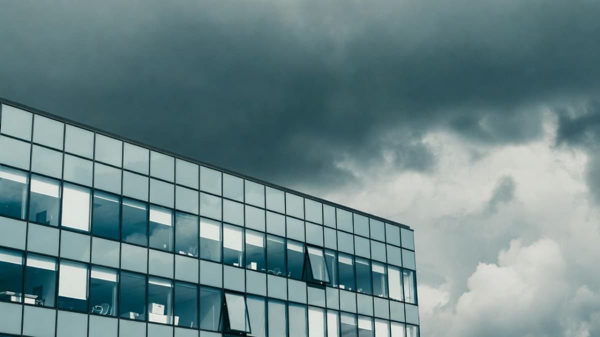 Atlassian logo on a corporate building exterior with overcast sky
