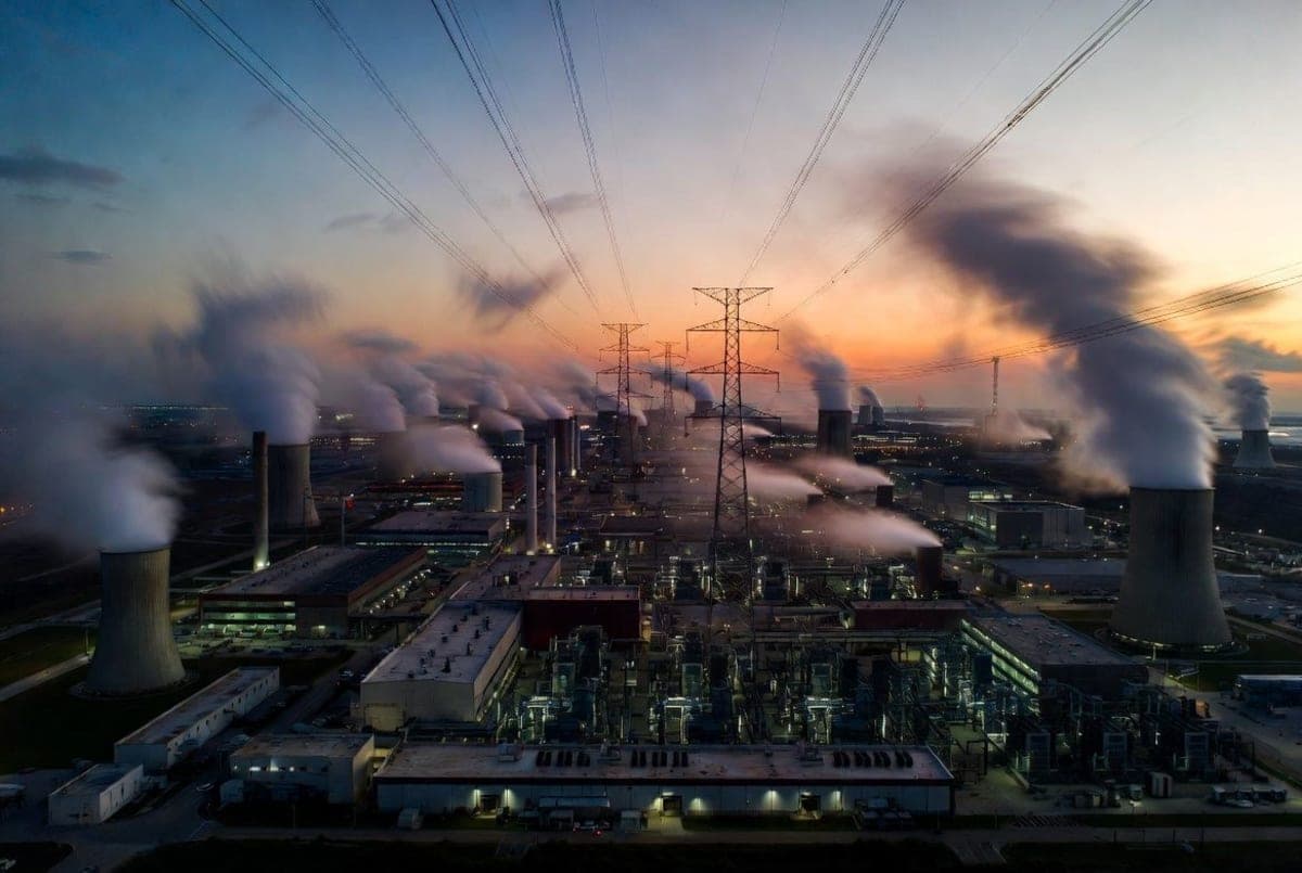 Server racks in a data center with blue and green indicator lights reflecting off polished floors