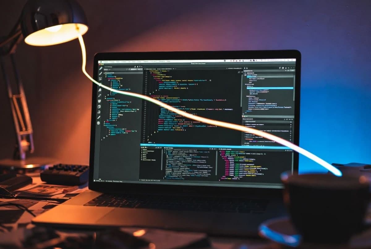A MacBook screen showing multiple overlapping application windows with a glowing cursor trail between them, suggesting an AI agent navigating between apps