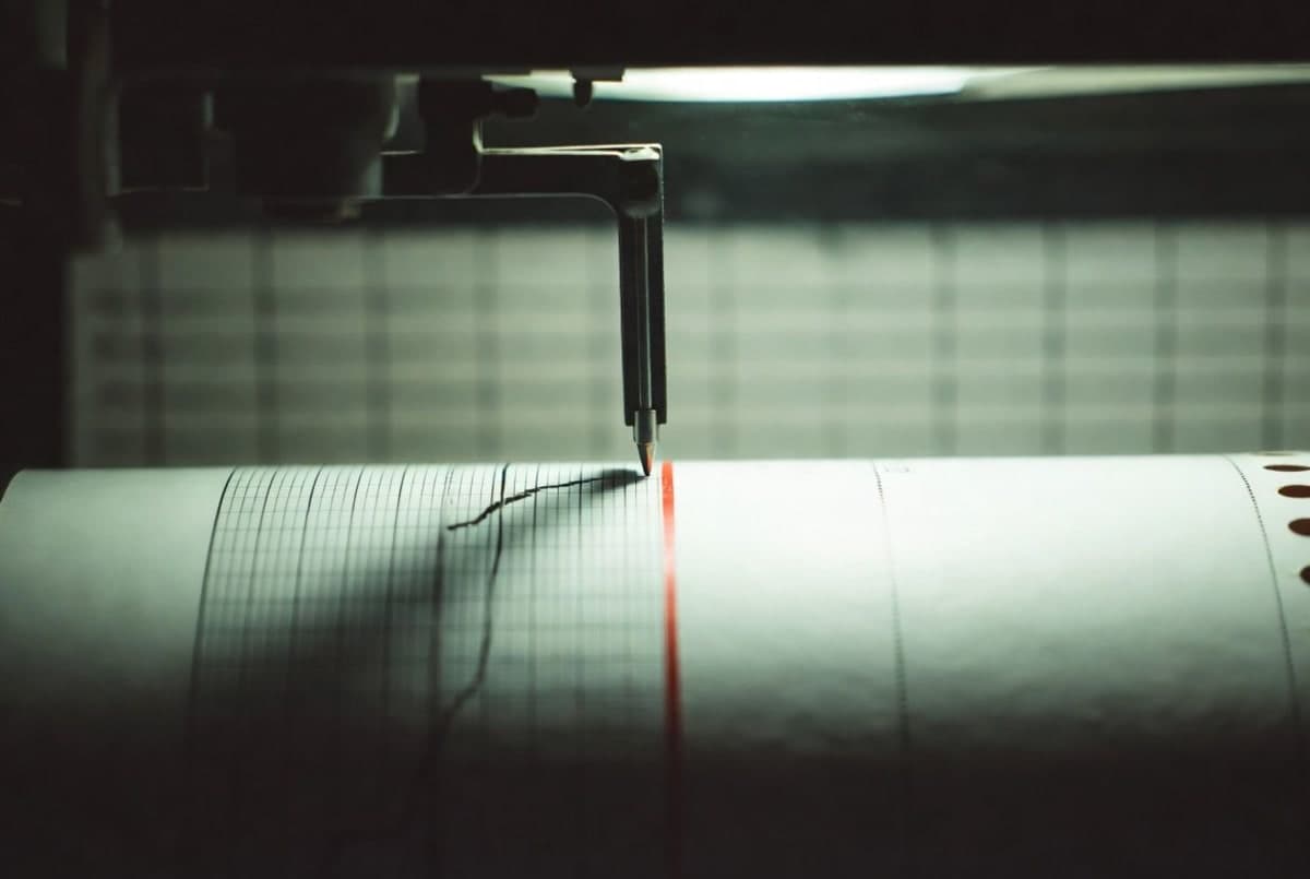 An analog chart recorder with its ink pen pressed against the upper printed limit of the paper roll.