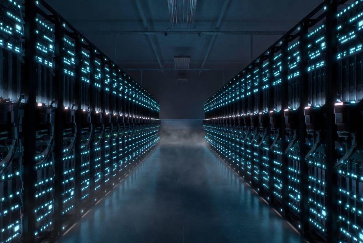 Rows of GPU server racks glowing in a large data center hall at night