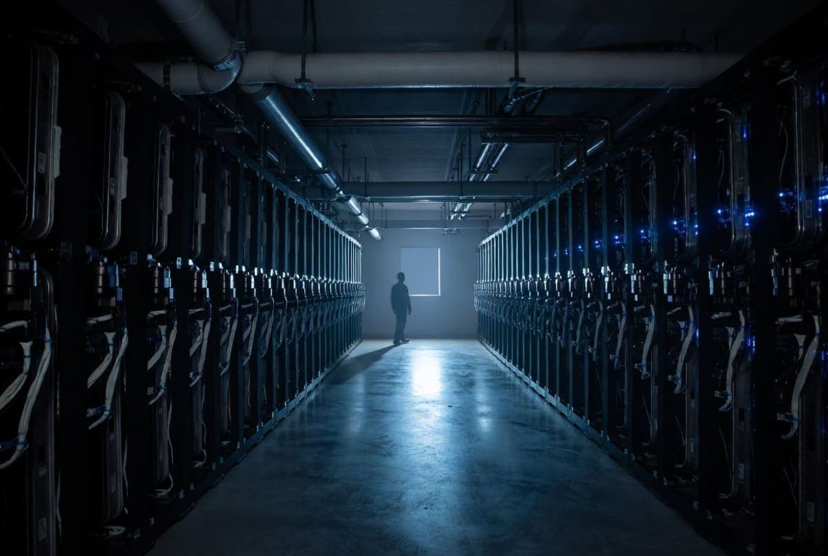 Rows of liquid-cooled servers glowing in a windowless classified government data center