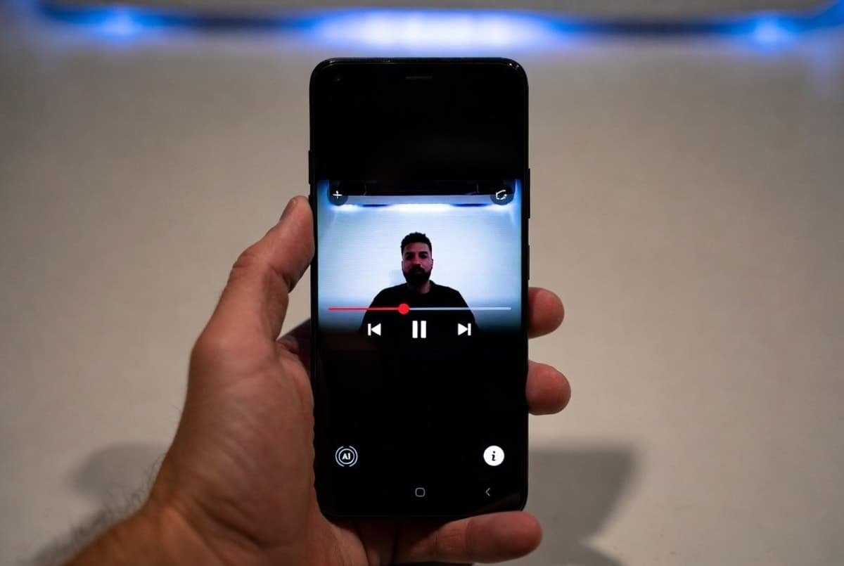 A smartphone displaying a YouTube video player with an AI-generated content disclosure label below it