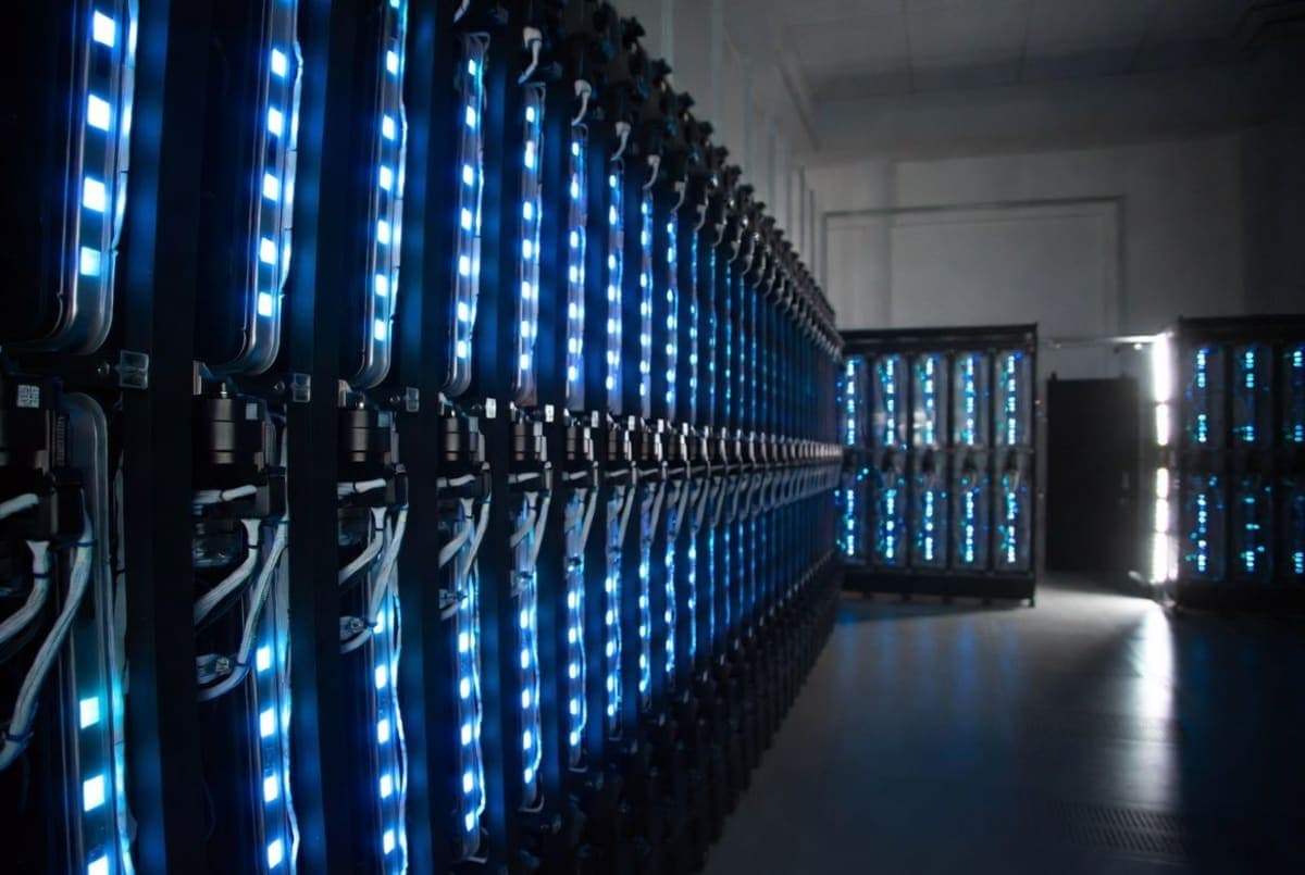 Abstract data center server racks lit in blue, representing a large language model running on cloud infrastructure