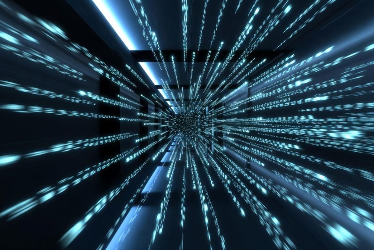 Abstract visualization of fast-streaming code tokens flowing through a dark server environment lit in blue