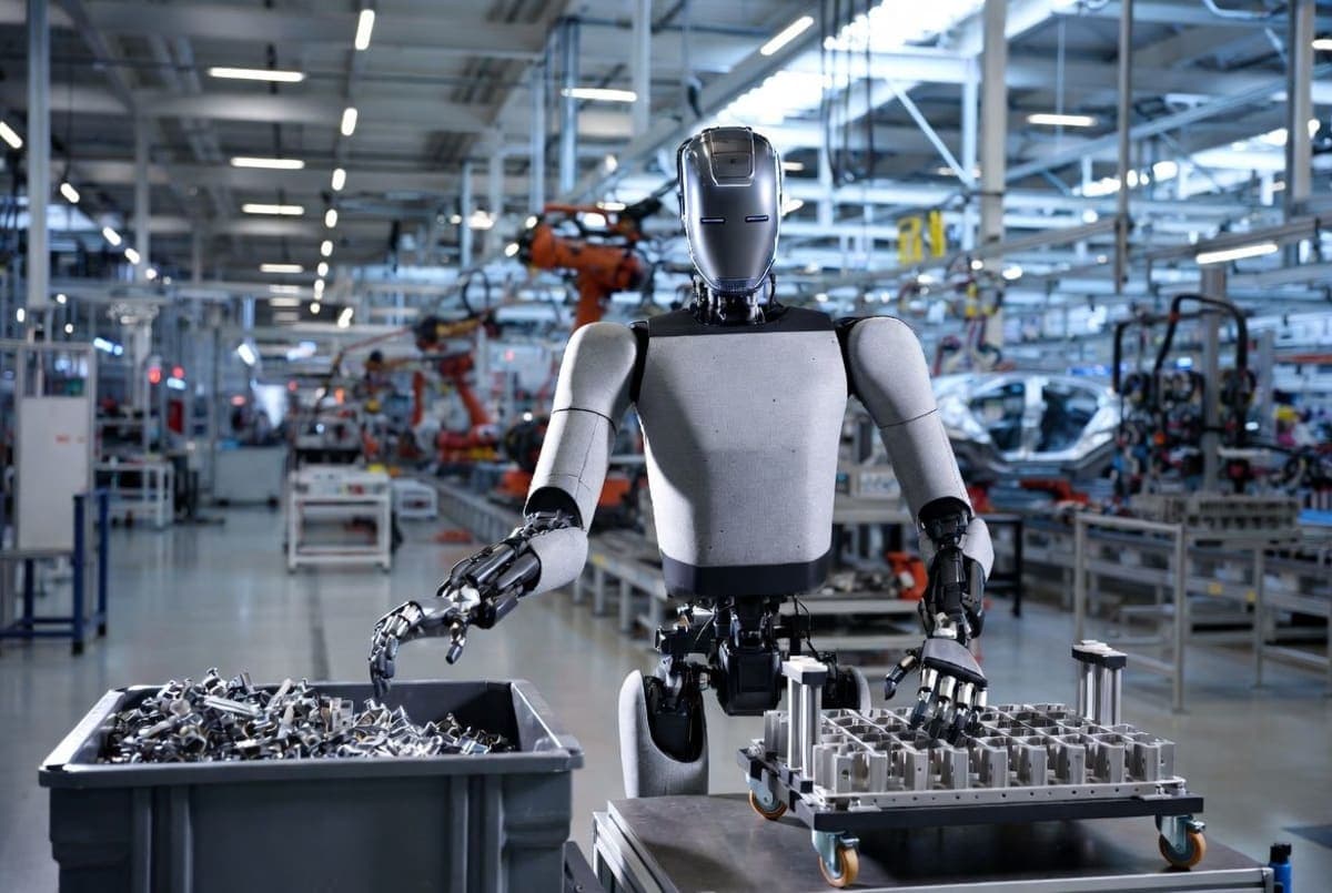 Humanoid robot sorting automotive components into a logistics trolley on a factory floor